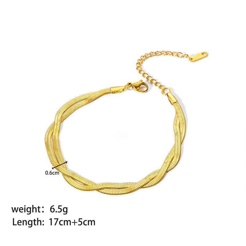 Gold bracelet with measurement details on a white background