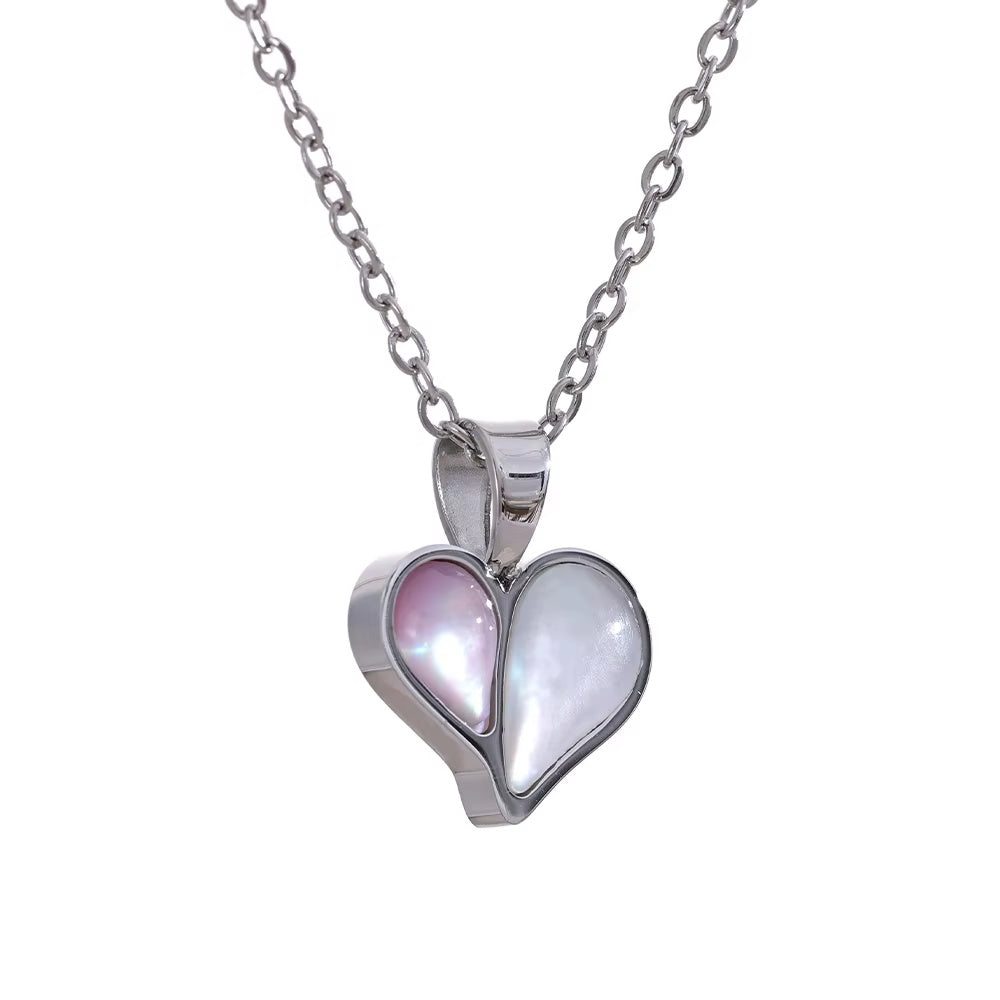 Heart-shaped pendant with pink and white interior on a silver chain against a white background