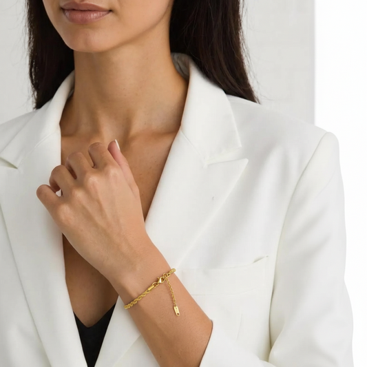 Woman wearing a gold bracelet on a white background
