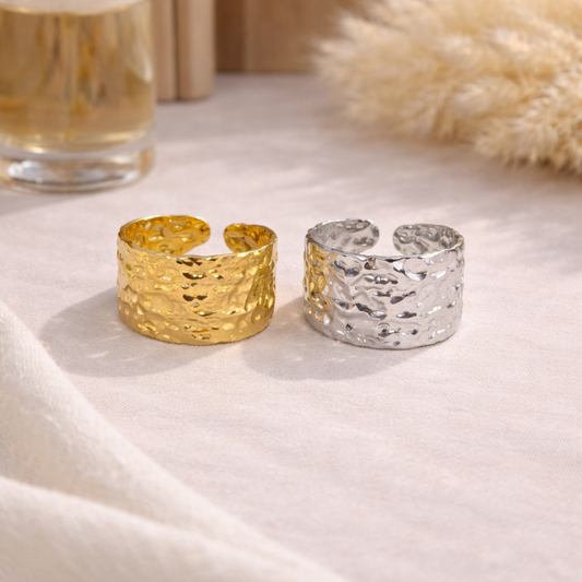 two statement rings, one in gold, second in silver color