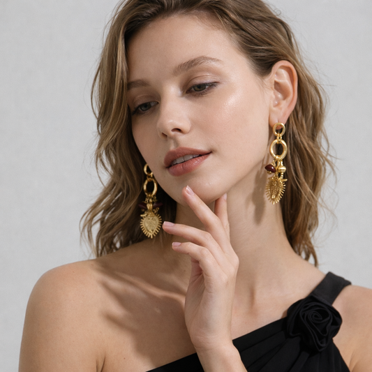 Woman wearing statement gold earrings with a neutral background