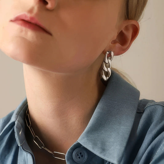 model wearing simple stainless steel chain earrings