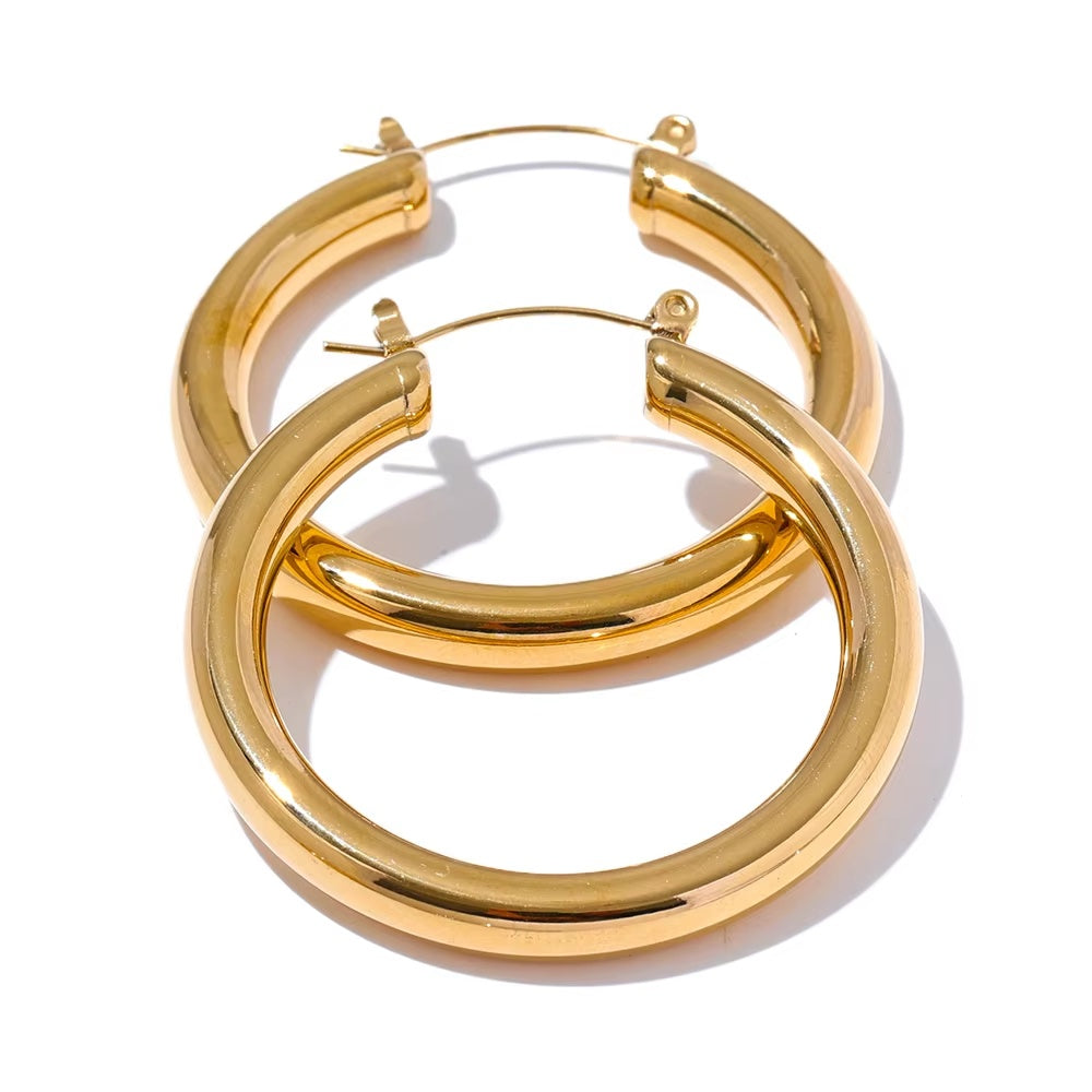 Pair of gold hoop earrings on a white background