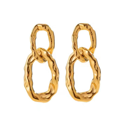 Gold chain-style earrings on a white background