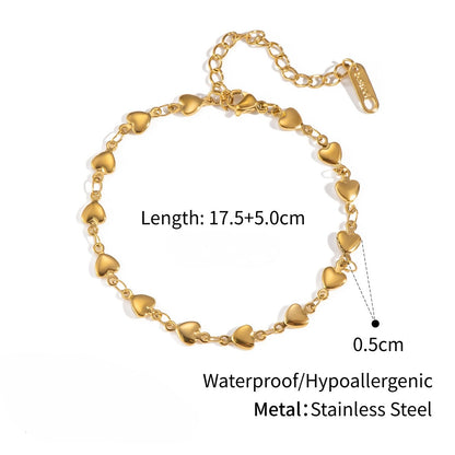 Gold heart-shaped bracelet with measurements and material details on a white background