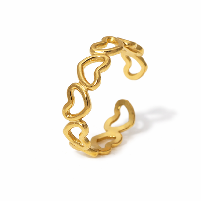 Gold heart-shaped ring on a white background