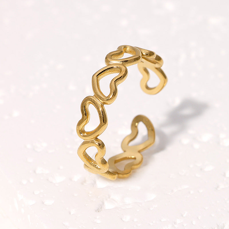 elegant Gold ring with heart-shaped links on a light background