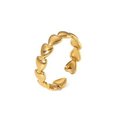 gold heart-shaped ring on white background
