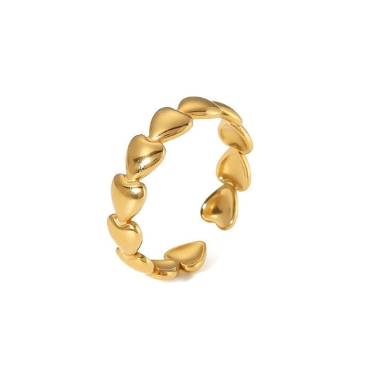 gold heart-shaped ring on white background