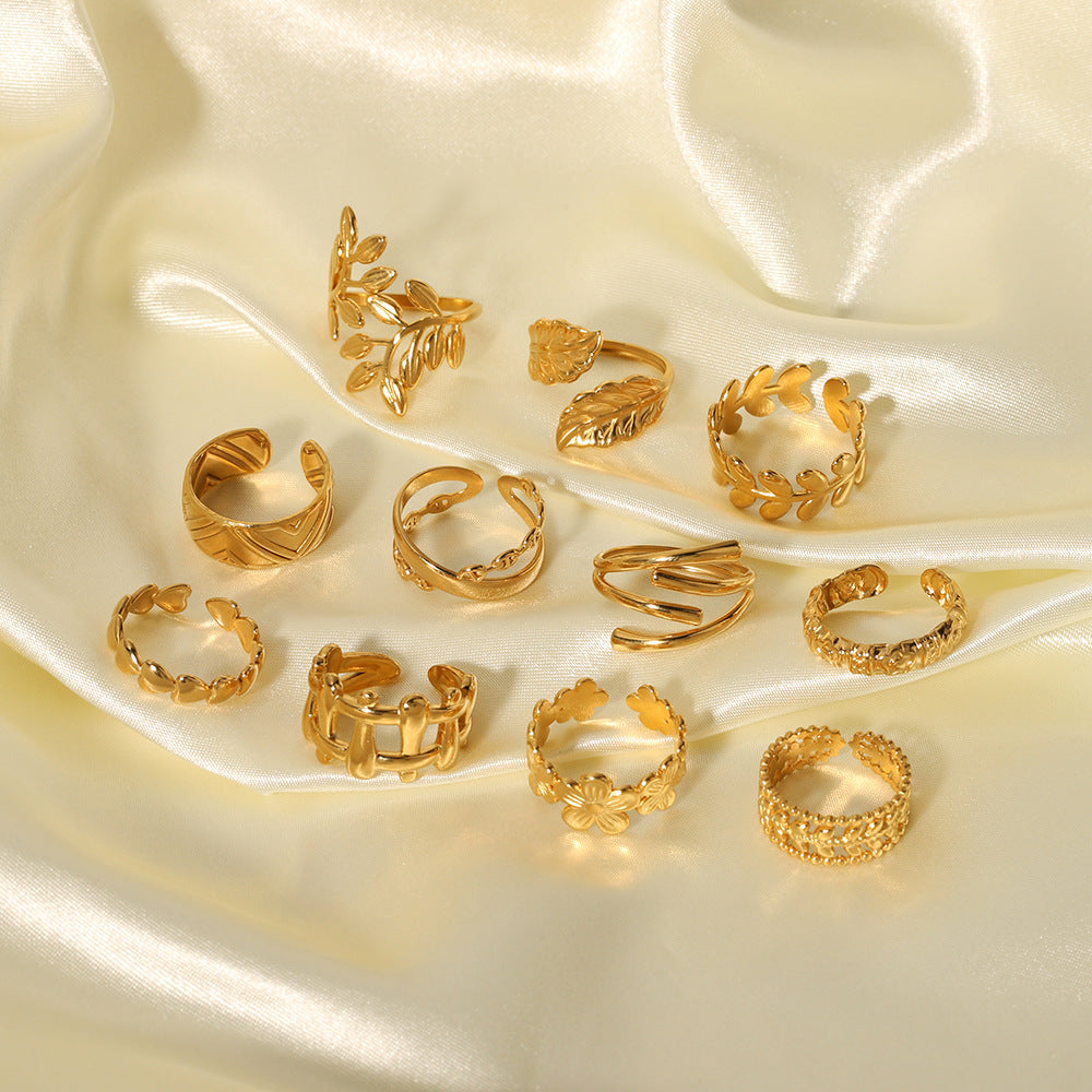 multiple gold stainless steel rings on satin fabric