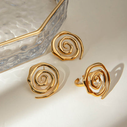 Gold spiral earrings on a light background