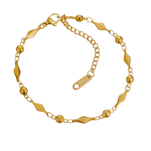 Gold bracelet with geometric designs on a white background