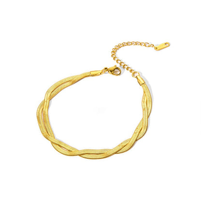 Gold stainless steel bracelet on a white background