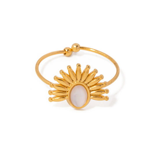 Gold ring with a sunflower design on a white background