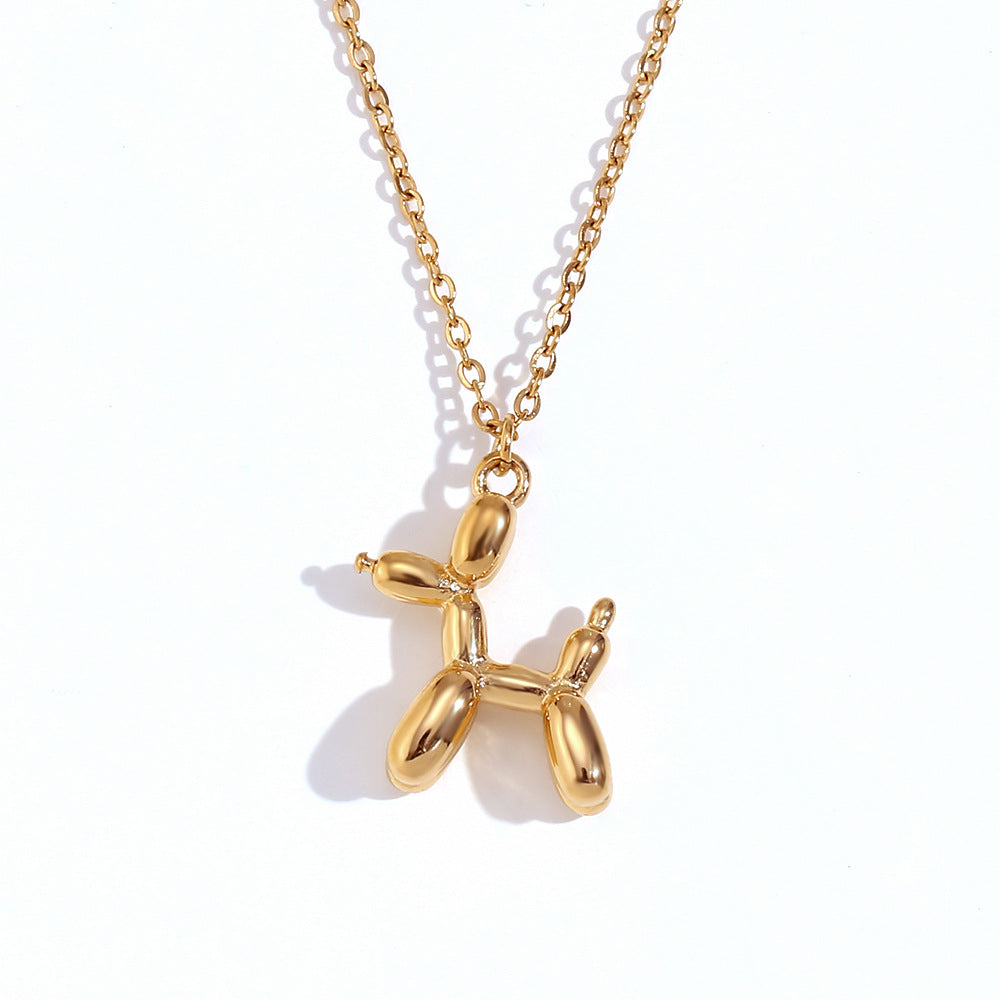 Gold stainless steel balloon dog pendant necklace on a white background