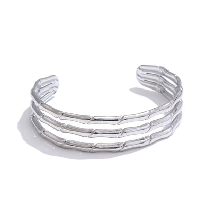 silver stainless steel bangle on white background