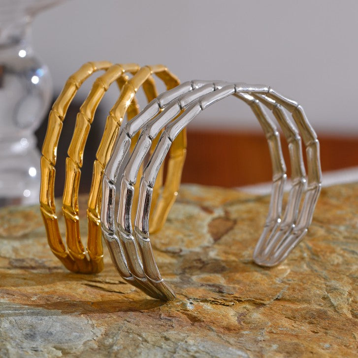 two statement bangles in gold and silver color