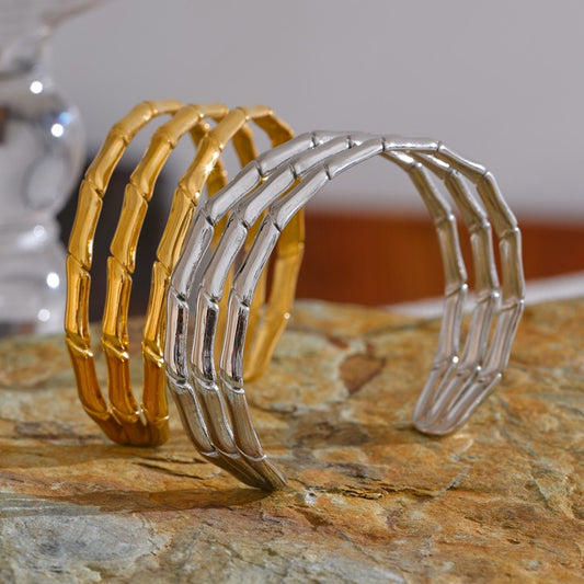 two statement bangles in gold and silver color