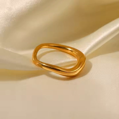 Gold ring on a beige fabric background