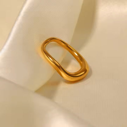Gold ring on a beige fabric background