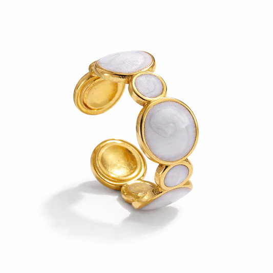 Gold ring with white stone on a white background