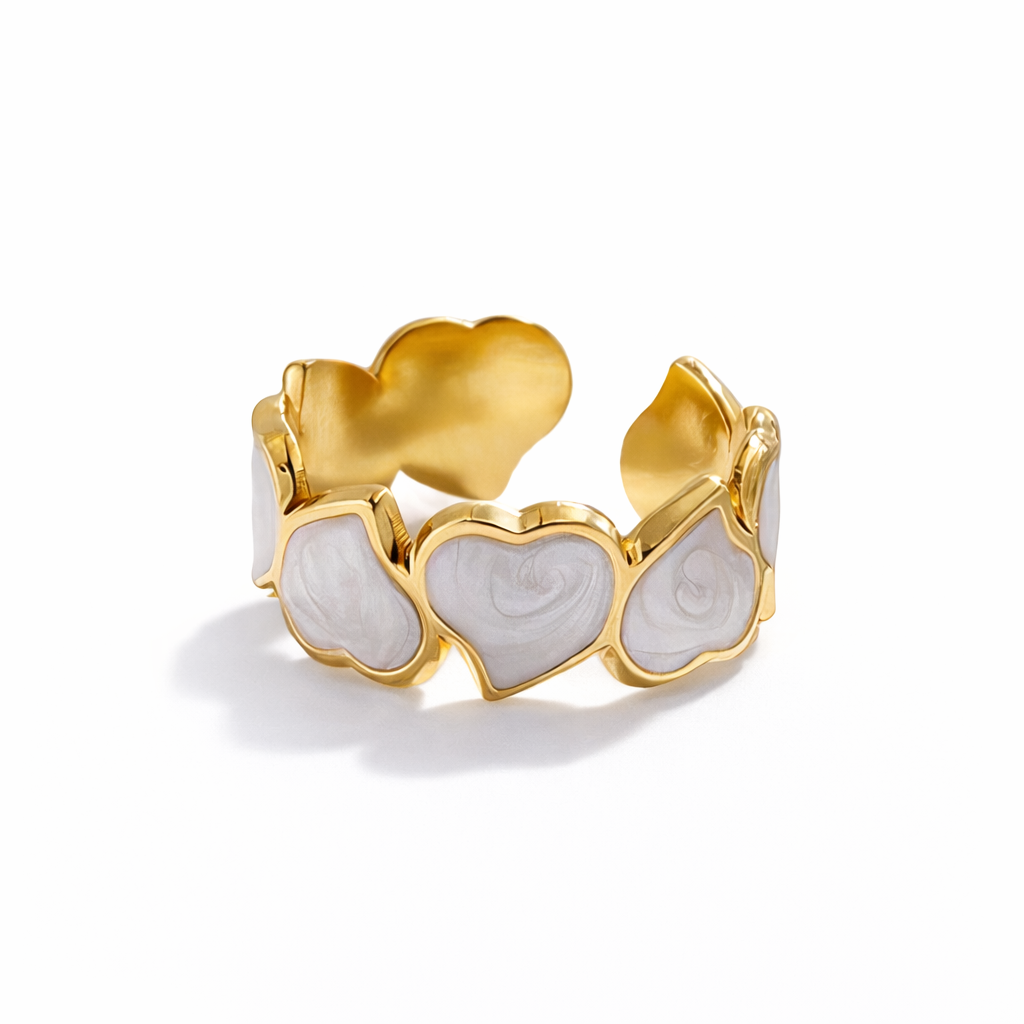 Gold ring with heart-shaped designs on a white background