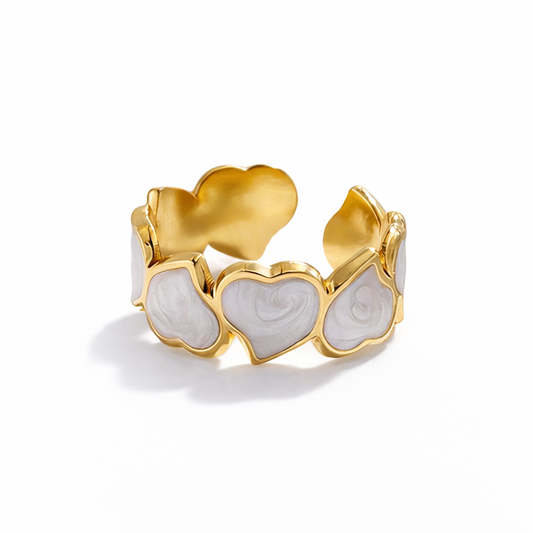Gold ring with heart-shaped designs on a white background