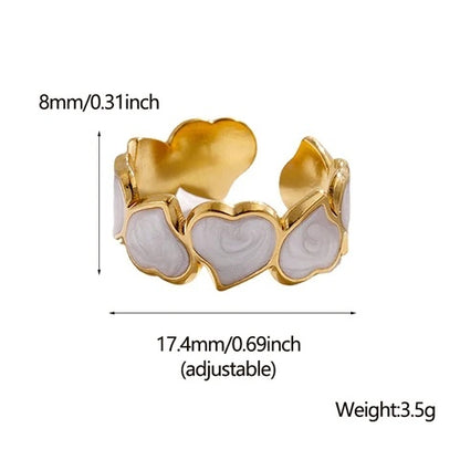 Gold and white heart-shaped ring with measurements and weight details on a white background