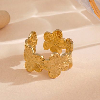 Gold floral ring on a beige background