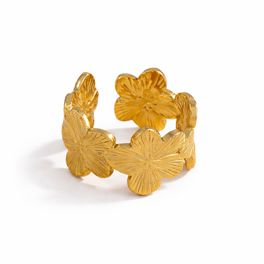 Gold floral ring on a white background