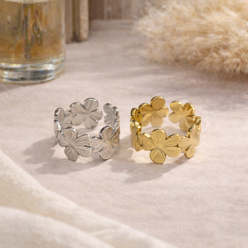 gold and silver rings with floral design on beige background