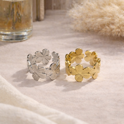 gold and silver rings with floral design on beige background