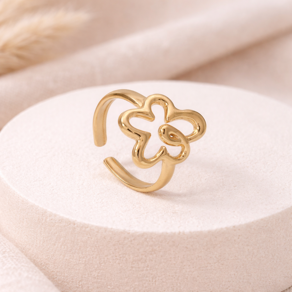gold flower-shaped ring on white background