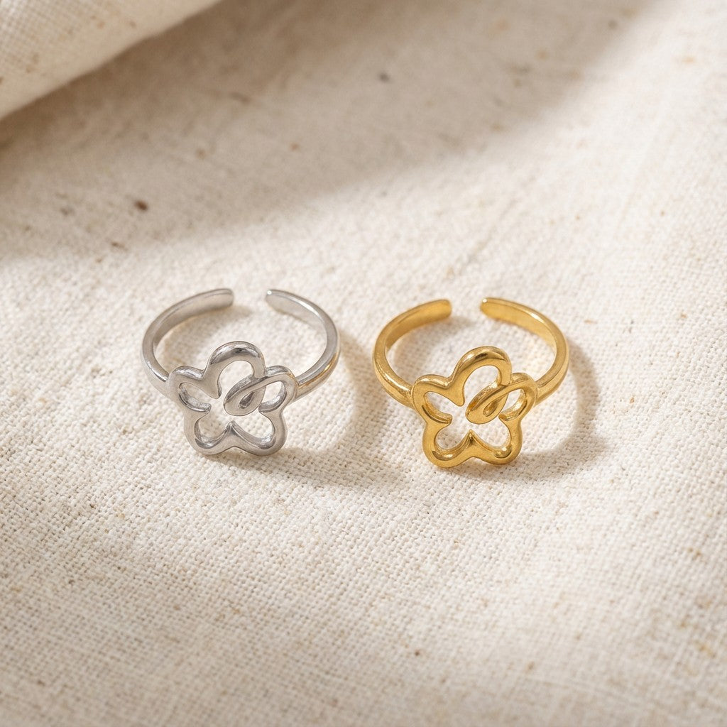 gold and silver flower-shaped rings on beige fabric