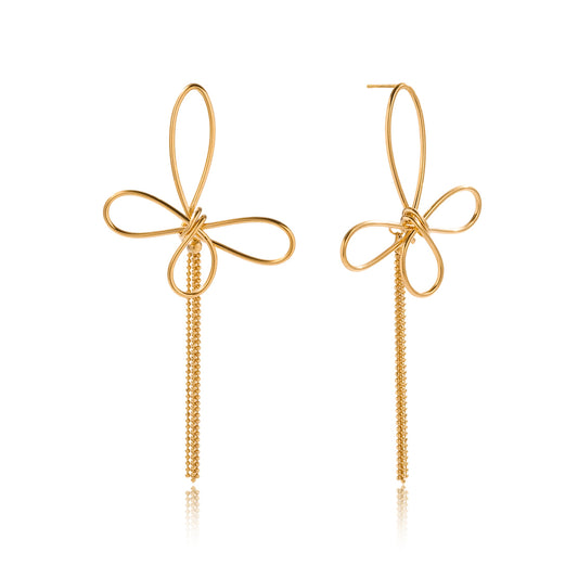 Gold bow-shaped earrings on a white background