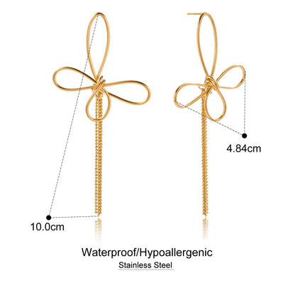 Gold bow-shaped earrings with measurements on a white background
