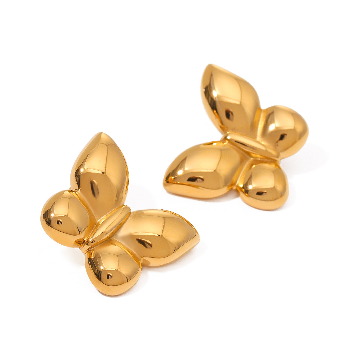 Pair of gold butterfly-shaped statement earrings on a white background