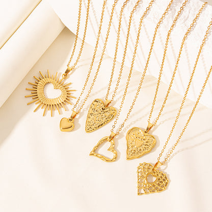 Gold necklaces with various heart-shaped pendants on a light background