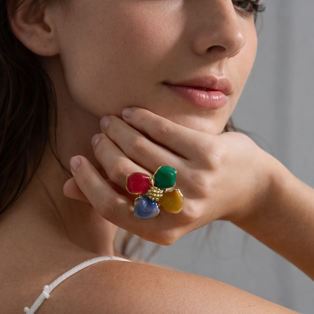Close-up of a woman wearing a colorful ring on her finger.