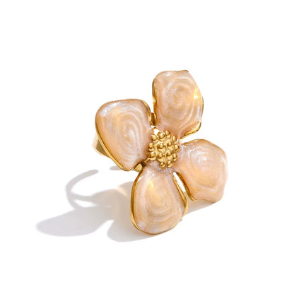 Floral-shaped ring with gold accents on a white background