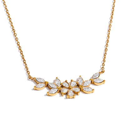 Gold necklace with zirconia flowers on a white background