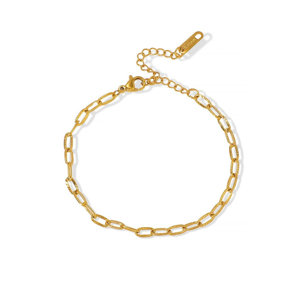 Gold stainless steel chain bracelet on a white background