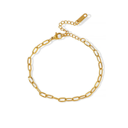 Gold stainless steel chain bracelet on a white background