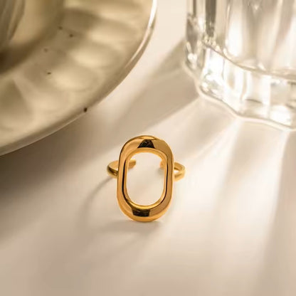 Gold ring on a light surface with a blurred background
