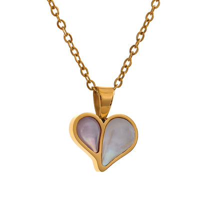 Gold heart-shaped pendant with a pink and white stone on a gold chain against a white background