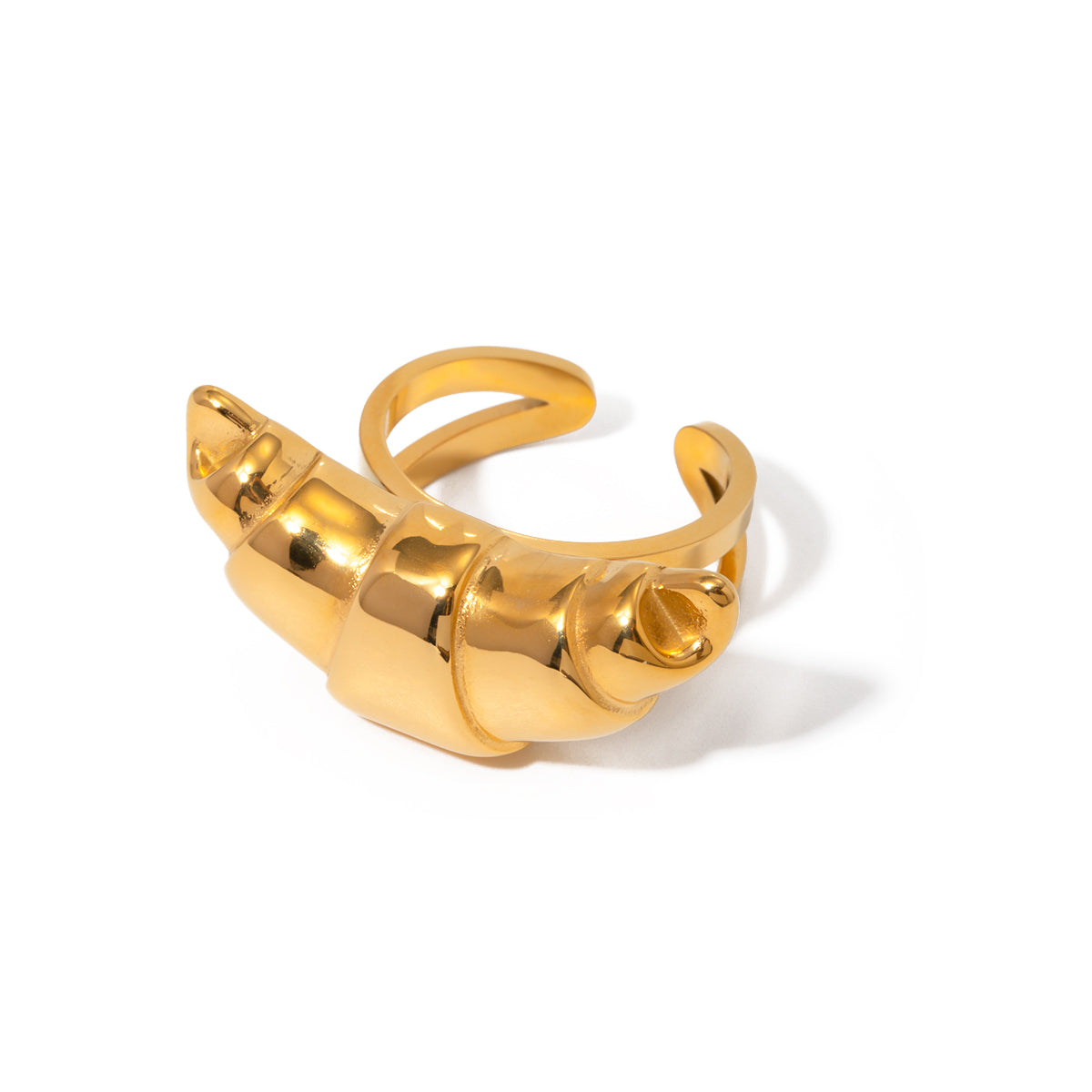 Gold croissant ring on a white background