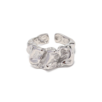 Silver chunky ring with a textured design on a white background