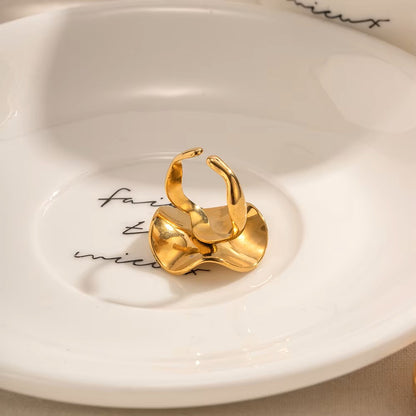 Gold ring on a white ceramic dish with text