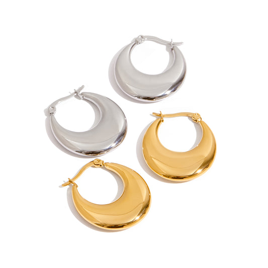 Set of silver and gold hoop earrings on a white background