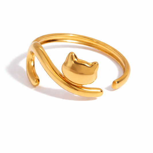 Gold cat-shaped ring on a white background